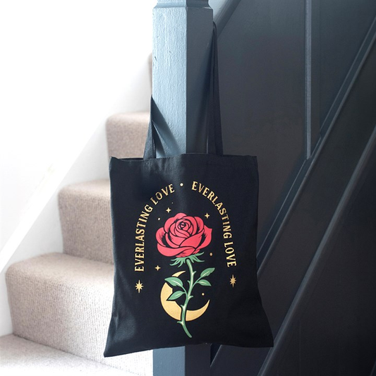 Everlasting Love black rose tote bag hanging on staircase