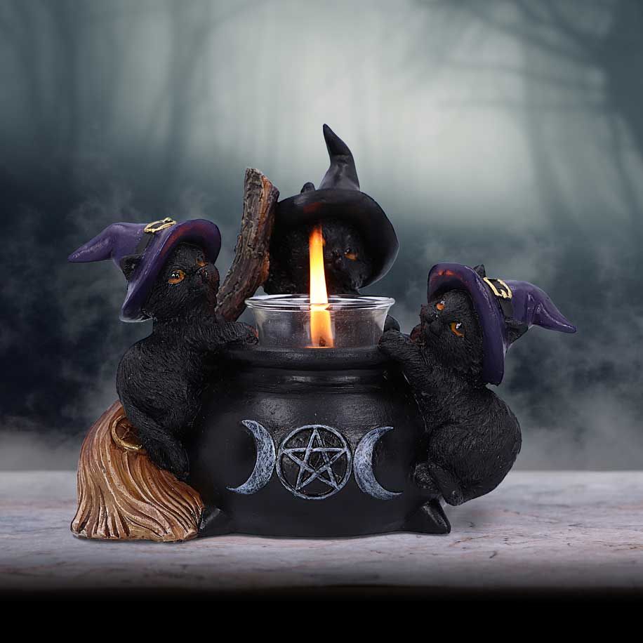 Black cat cauldron candle holder in gothic setting