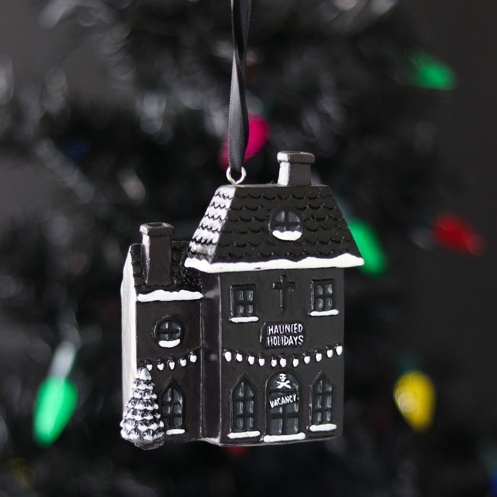 1. Haunted House Christmas Bauble hanging on a festive tree