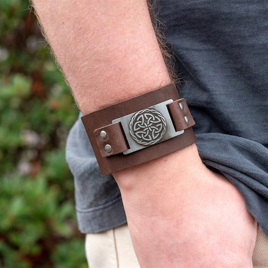 Brown Celtic shield knot leather cuff bracelet worn on wrist