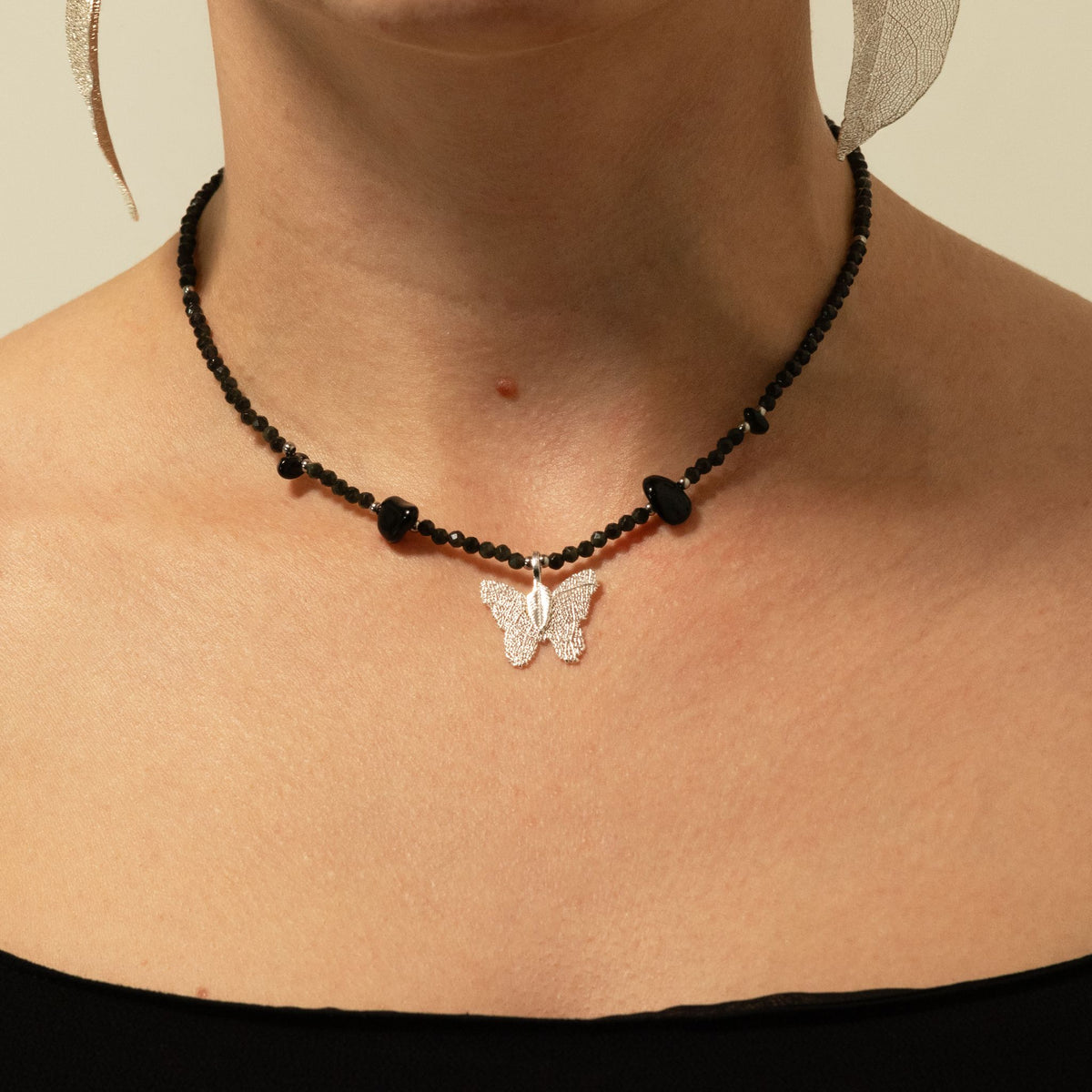 1. Nymph Black Obsidian gemstone necklace worn around the neck