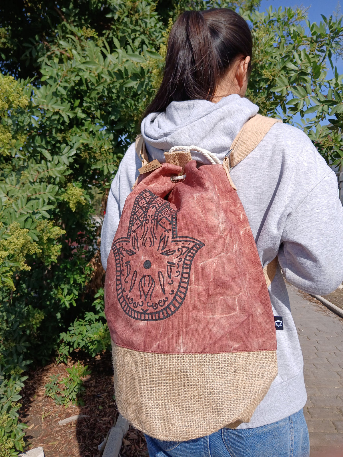 Terracotta Hamsa backpack worn on back