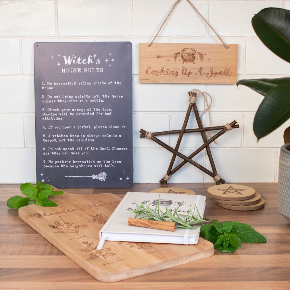 Witchy home decor display with pentagram ornament and wooden signs