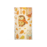 Candle with hedgehog and owl design on a white background