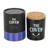 Candle with 'The Coven' branding and cork lid on a white background