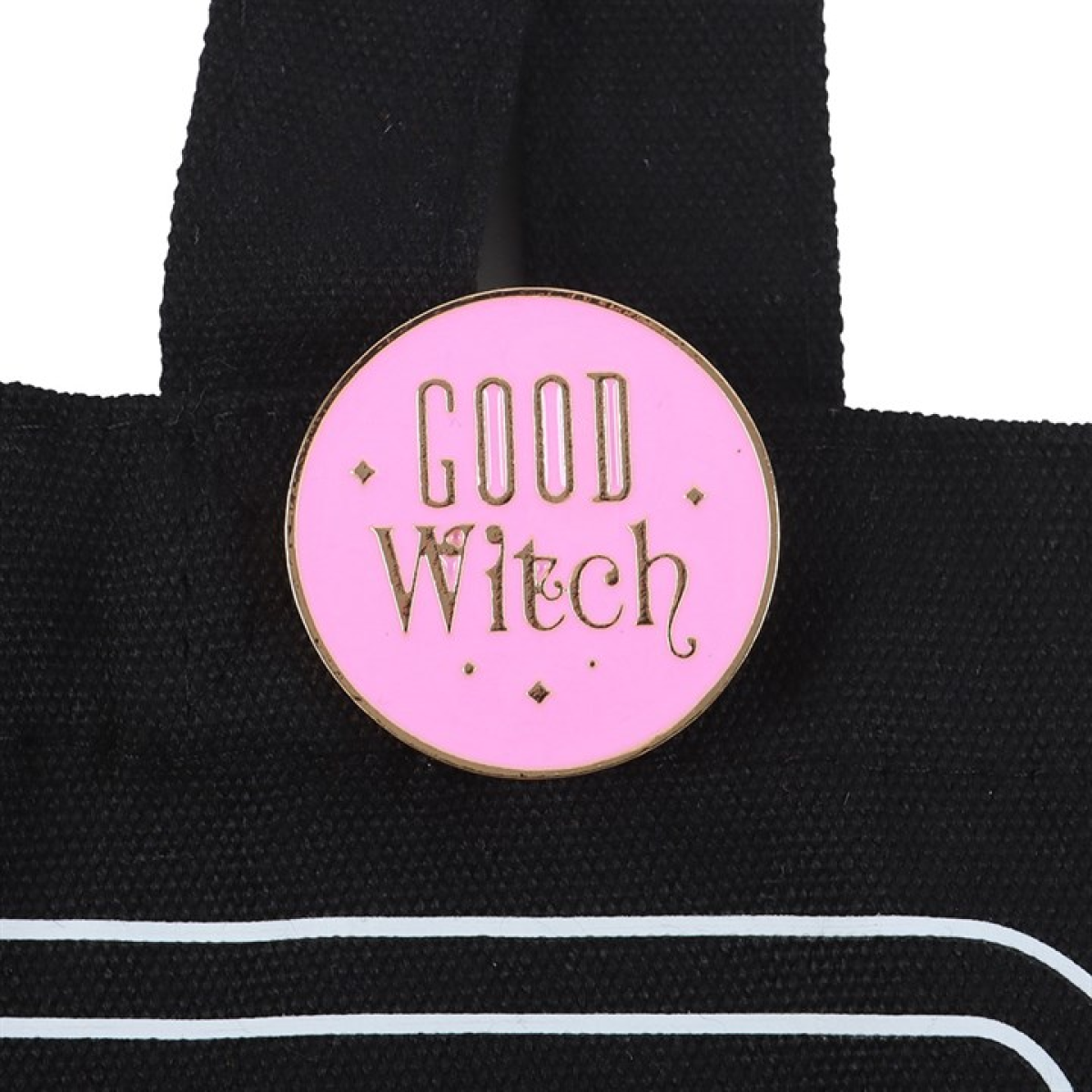 Pink Good Witch enamel pin badge attached to black tote bag