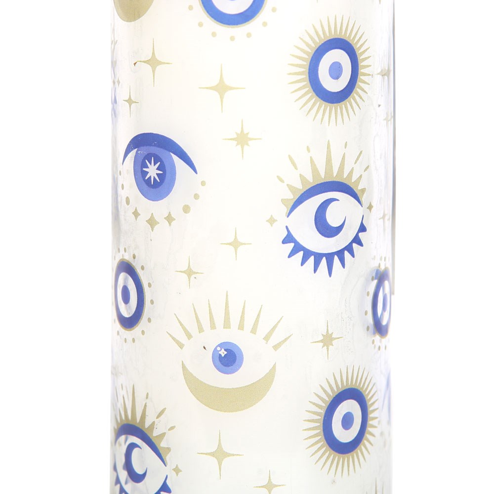 Close-up of blue and gold all-seeing eye candle design
