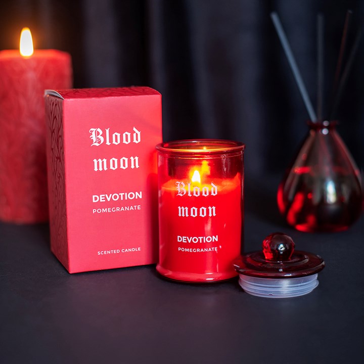 Blood Moon Pomegranate scented candle in red glass container