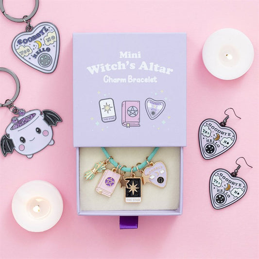 Mini witch's altar charm bracelet set with packaging on a pink background