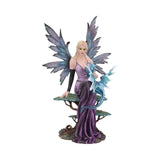 Fairy figurine with purple dress and blue wings holding a dragon on a white background