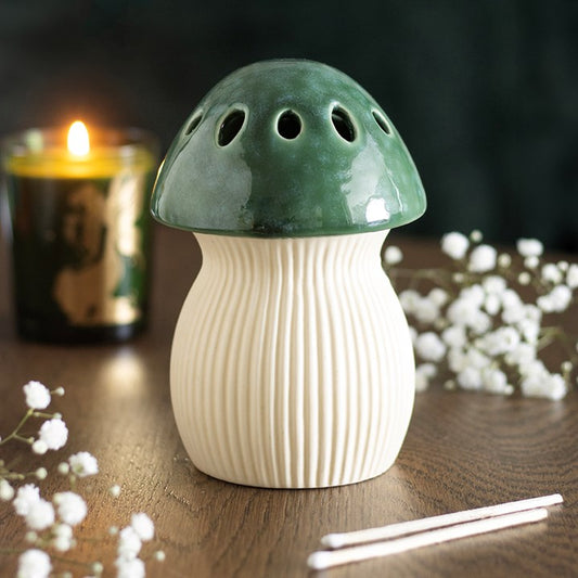 Green mushroom oil burner in woodland setting