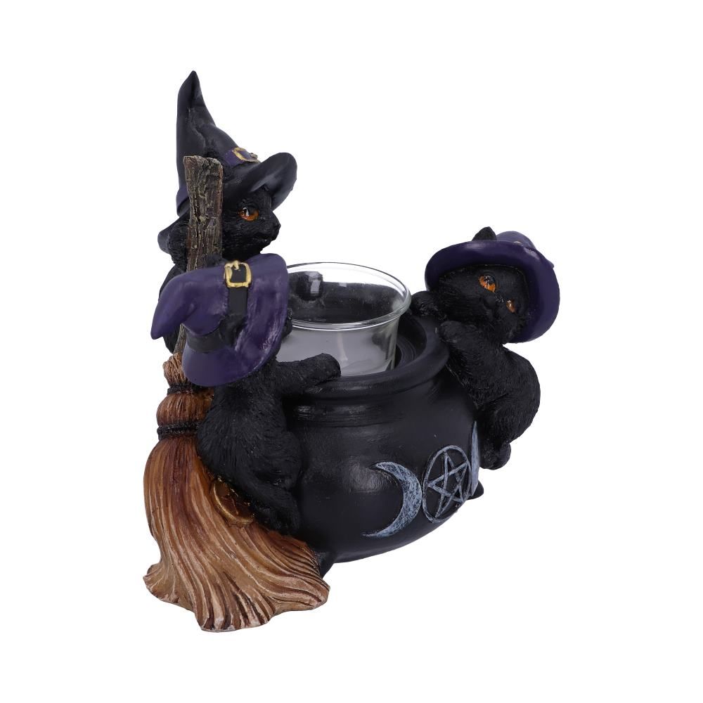 Side view of black cat cauldron candle holder