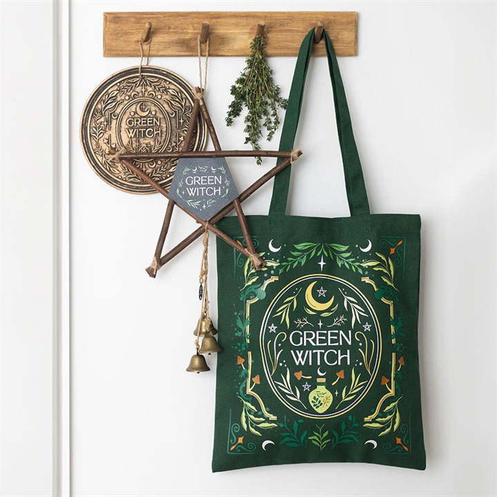 Green Witch tote bag hanging with witchy accessories