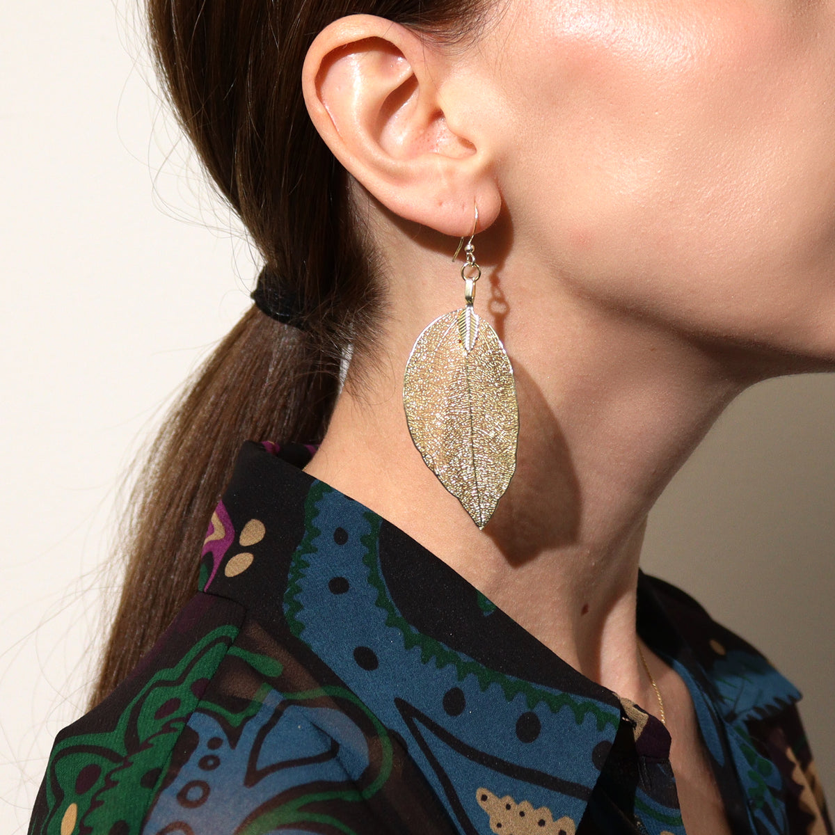Gold real leaf drop earrings being worn