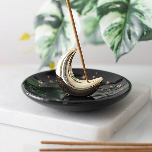 Gold crescent moon incense stick holder in use