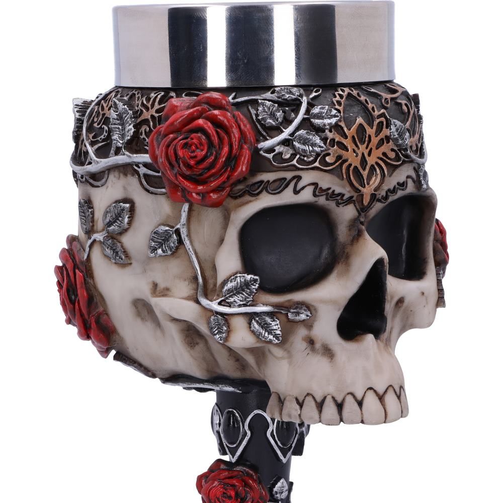 Close-up of skull, red rose and jewel details on gothic goblet