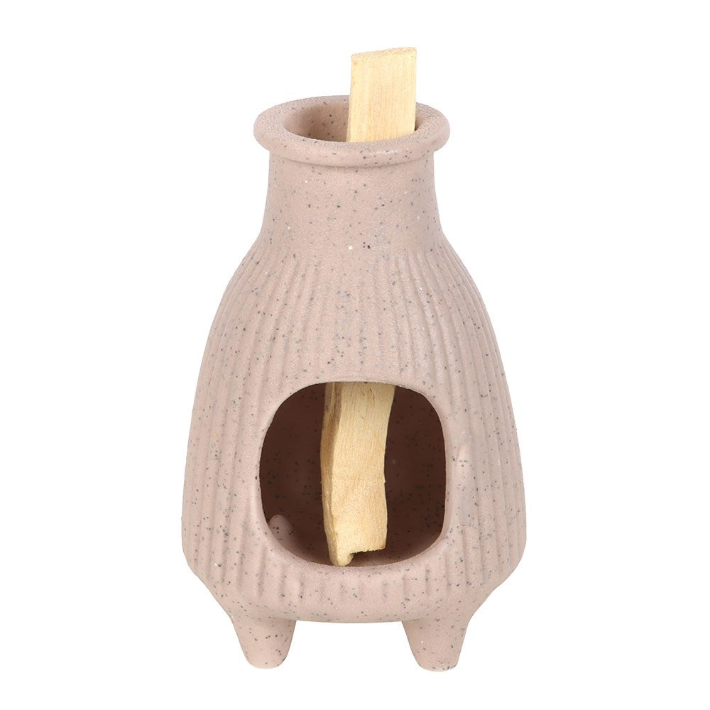 Greige ceramic burner holding Palo Santo