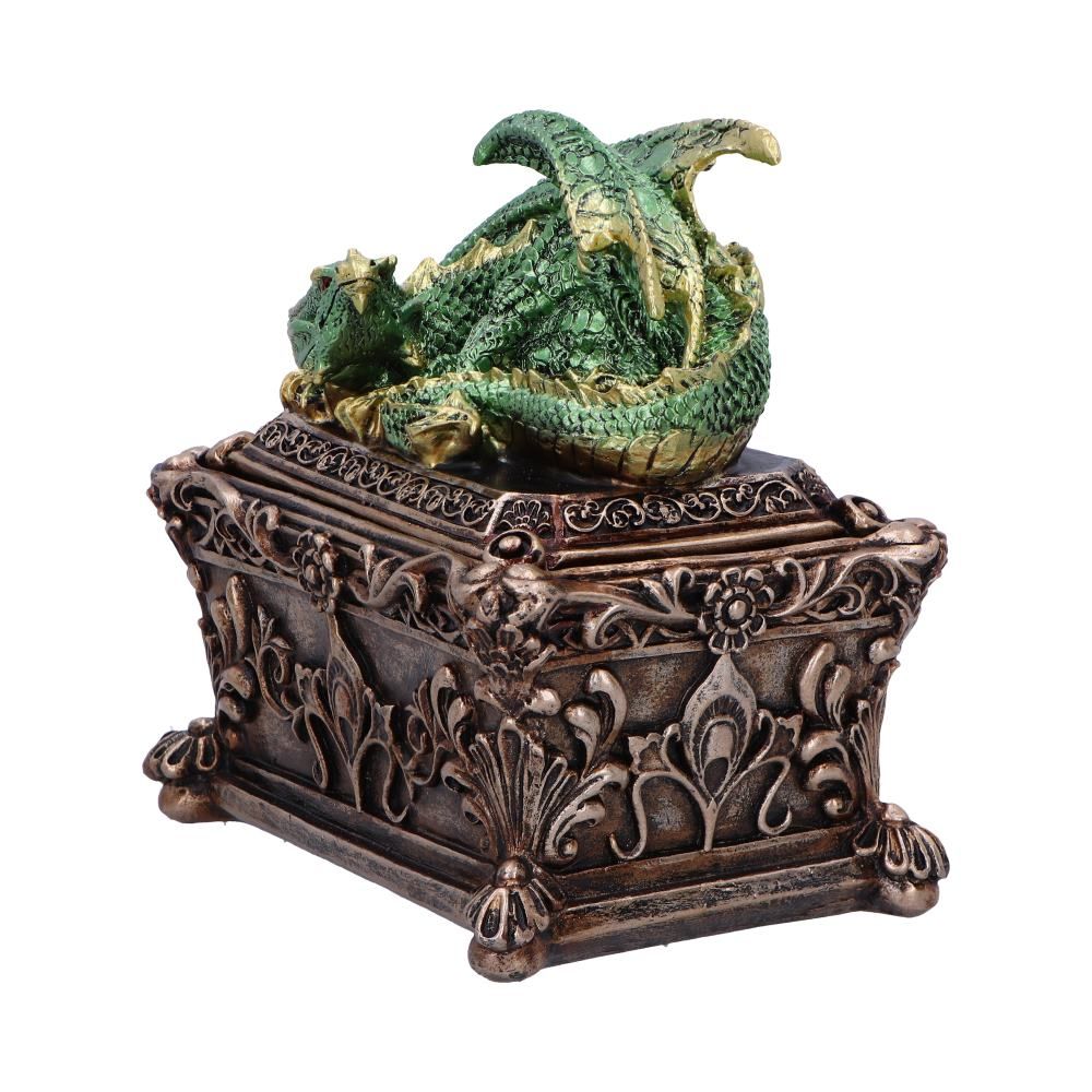 Side view of green dragon resting on ornate storage box