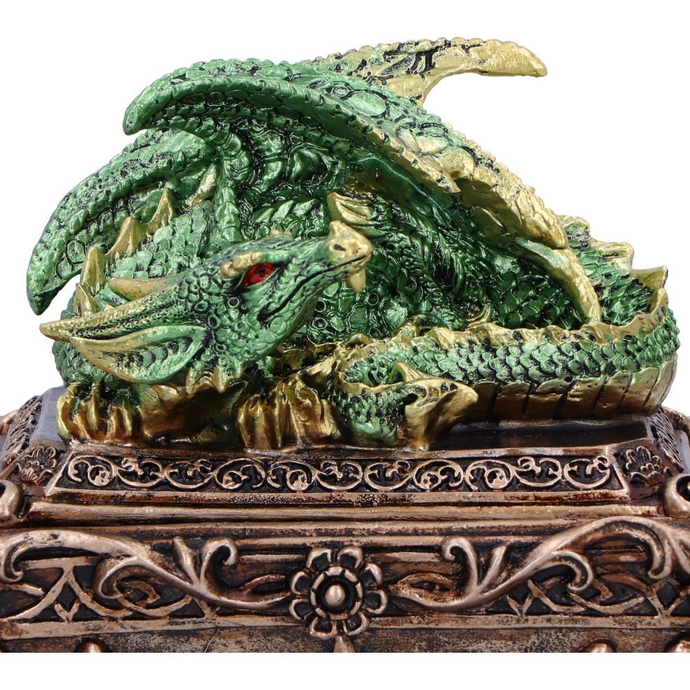 Close-up of green dragon and decorative bronze-effect chest