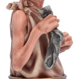 Close-up of Dobby holding his treasured sock