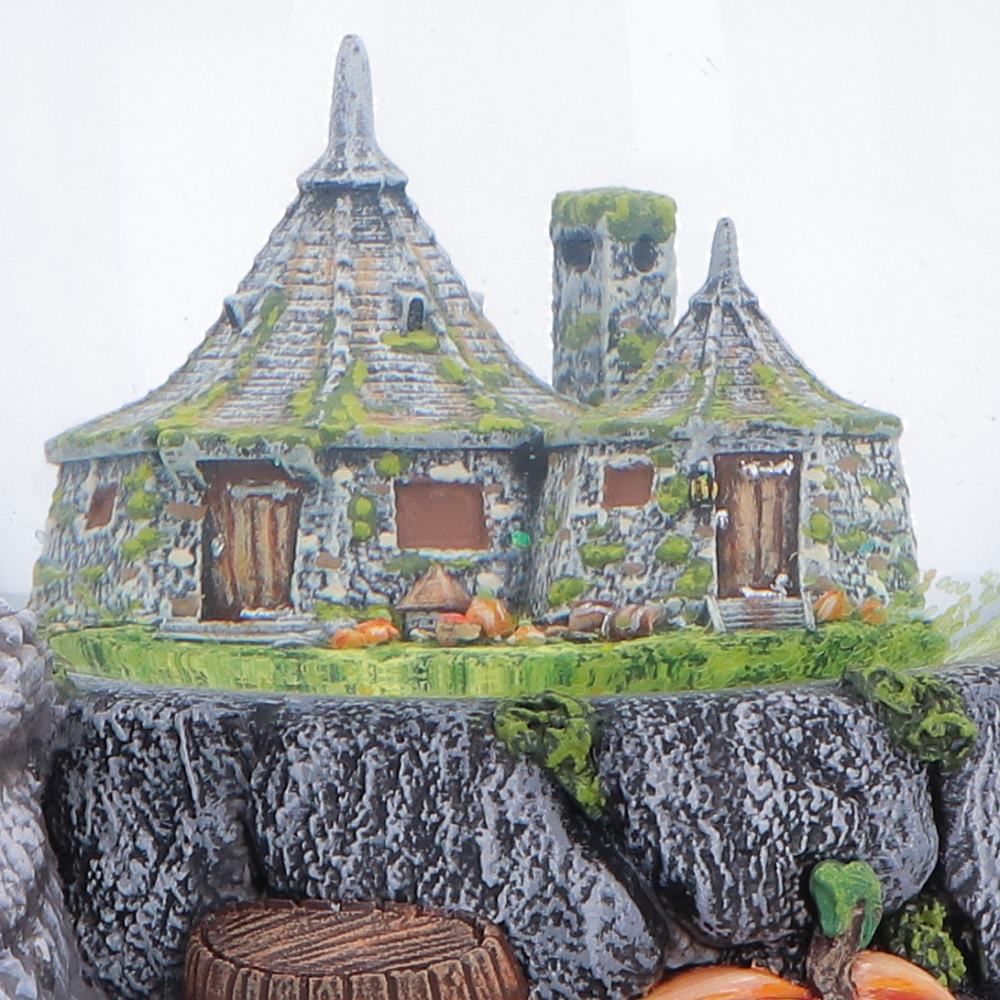 Close-up of the miniature Hagrid’s Hut inside the snow globe