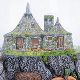 Close-up of the miniature Hagrid’s Hut inside the snow globe