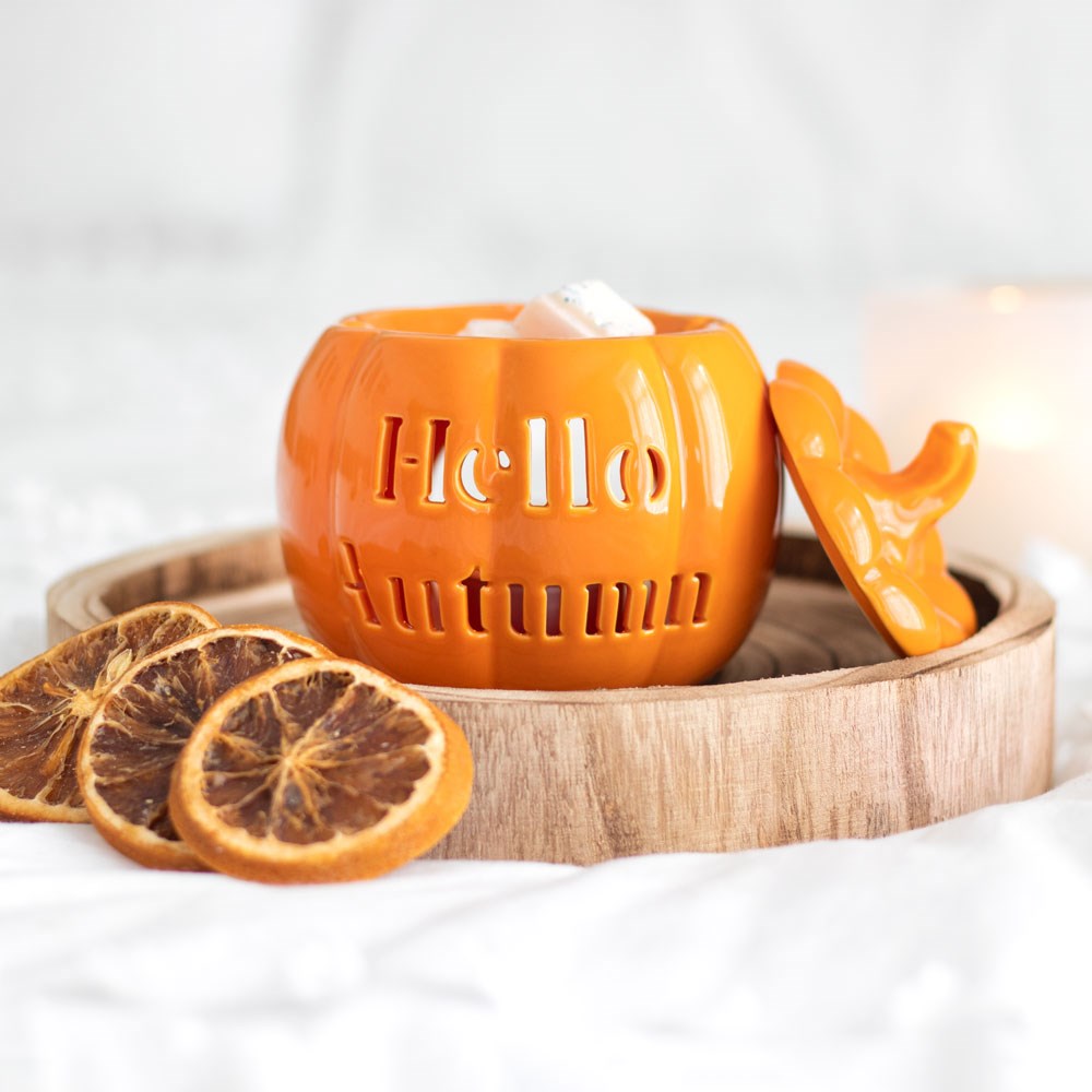 Hello Autumn pumpkin wax melt burner displayed with dried orange slices