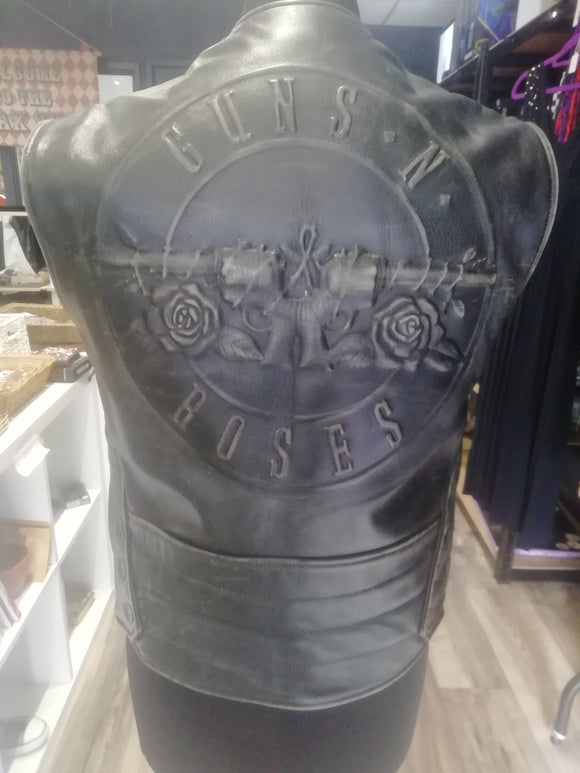 Black leather vest with 'Guns N' Roses' logo on a mannequin torso.