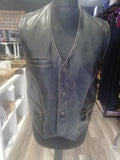 Black leather vest on a mannequin in a store setting