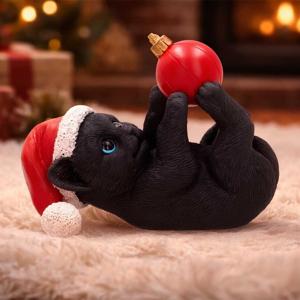 Jingle Paws black cat figurine displayed with Christmas decorations