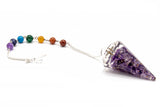 Crystal pendulum with chakra beads on a white background