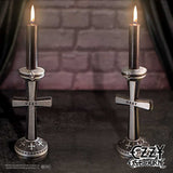 Pair of Ozzy Osbourne candle holders displayed with lit candles