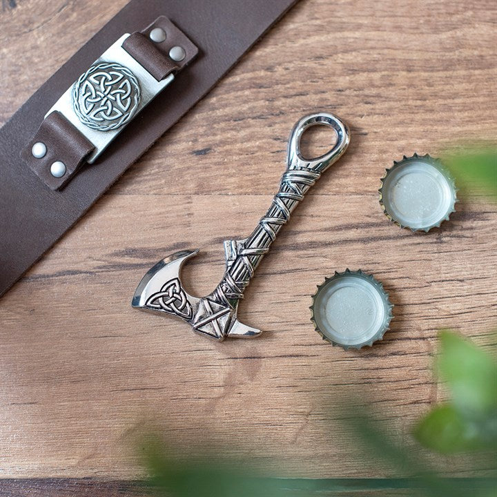 Celtic axe shaped metal bottle opener with knotwork design on display