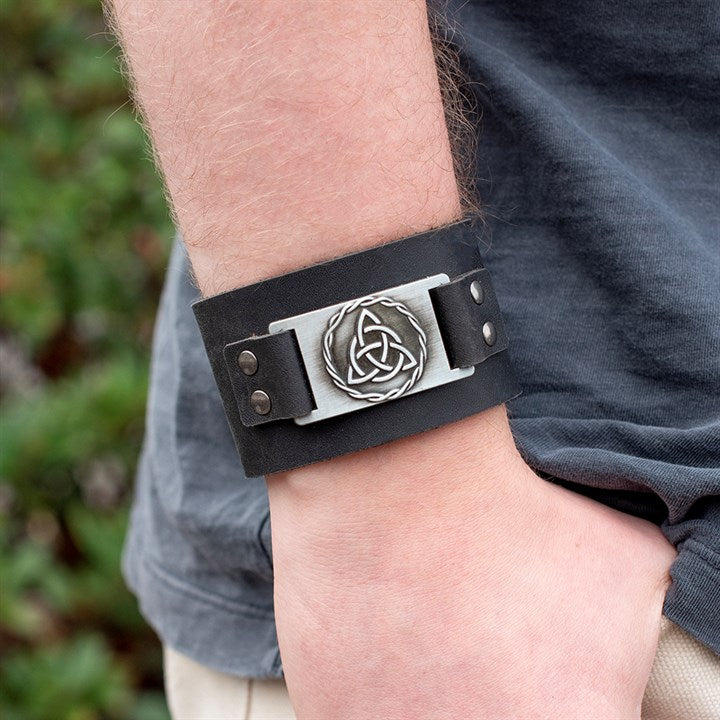 Black Celtic triquetra leather cuff bracelet worn on wrist