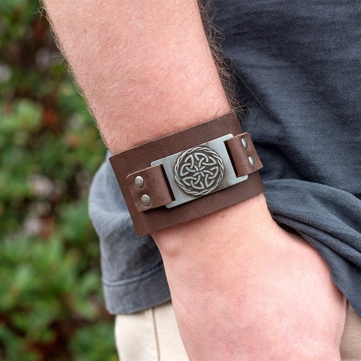 Brown Celtic shield knot leather cuff bracelet worn on wrist