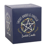 A dark blue square box for a scented candle, featuring a white pentagram inside a floral wreath and the text 'SMOKY AMBER & VANILLA' and 'Scented Candle'.