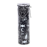Candle in a black glass jar with white designs on a white background
