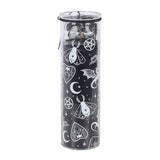 A tall, cylindrical clear glass jar filled with black wax and decorated with white occult-themed illustrations including moons, stars, pentagrams, and butterflies, topped with a clear lid.