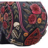 Close-up of floral and planchette artwork on rear of skull