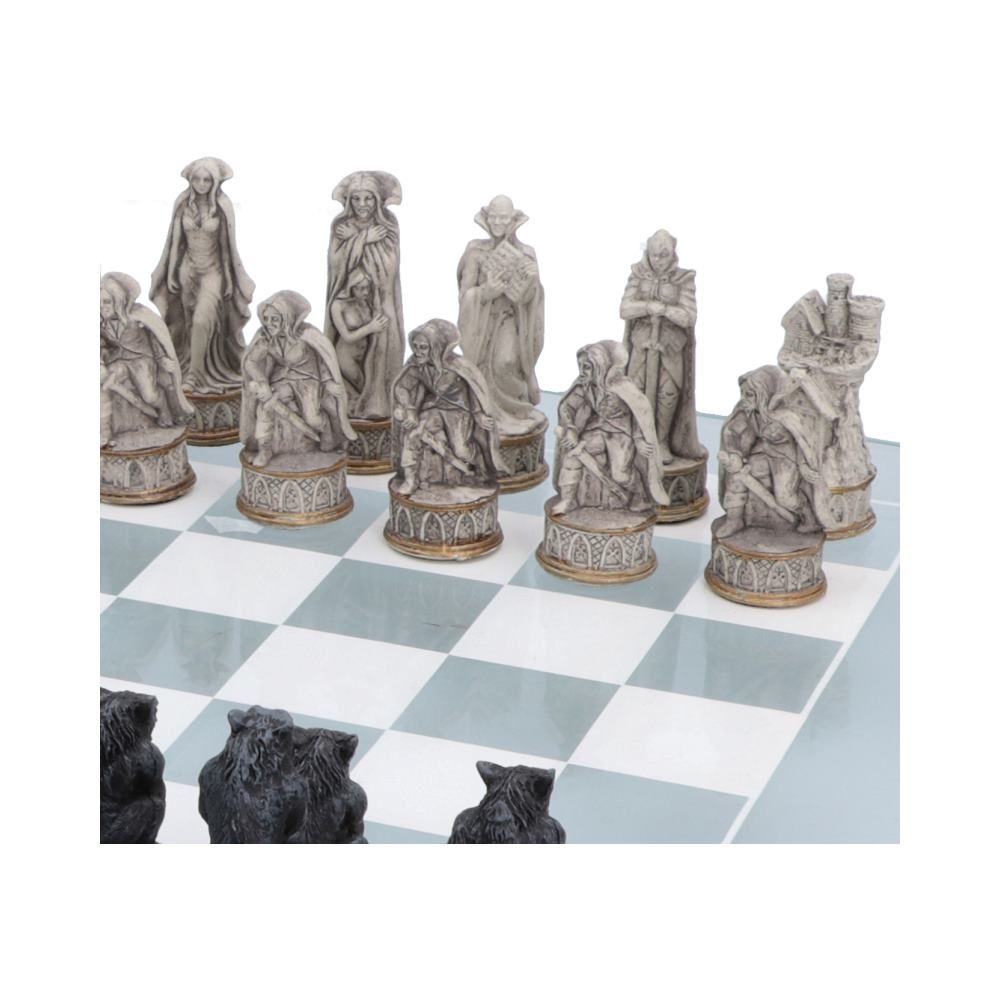 Vampire chess pieces on decorated glass chess board