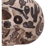 Close-up of cowboy boot and frontier artwork on the skull