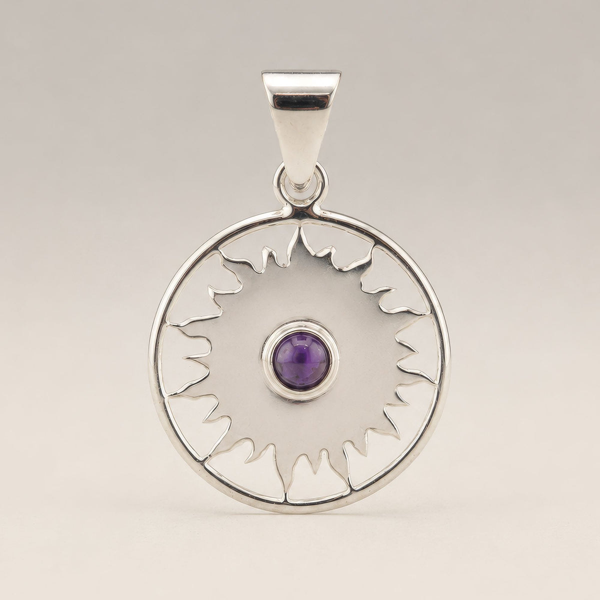 Silver-plated sun pendant with purple centre stone