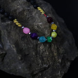 Multicolored beaded bracelet on a dark stone surface