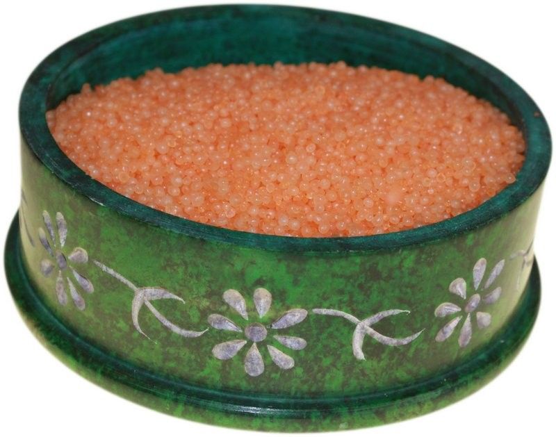 Simmering fragrance granules displayed in decorative bowl