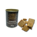 Amber incense resin canister with square resin pieces on a white background