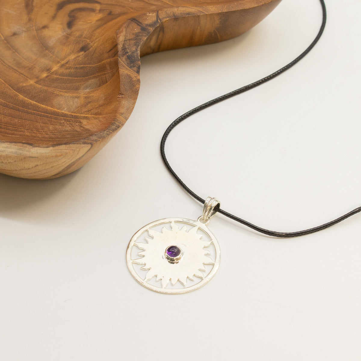 Celestial sun pendant necklace purple stone on display