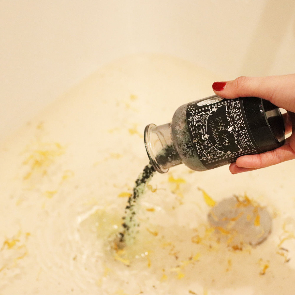 Ancient Witch Bath Spell Potion with floating botanicals in bath