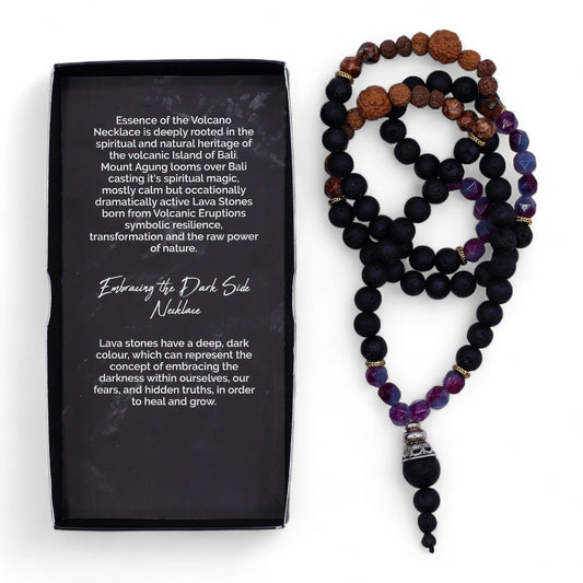 Necklace with black, brown, and purple beads next to a black box with text on a white background