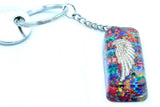 Keychain with multicolored resin and silver angel wing design on a white background