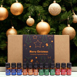 Set of Christmas fragrance oils with decorative boxes and gold ornaments on a green background
